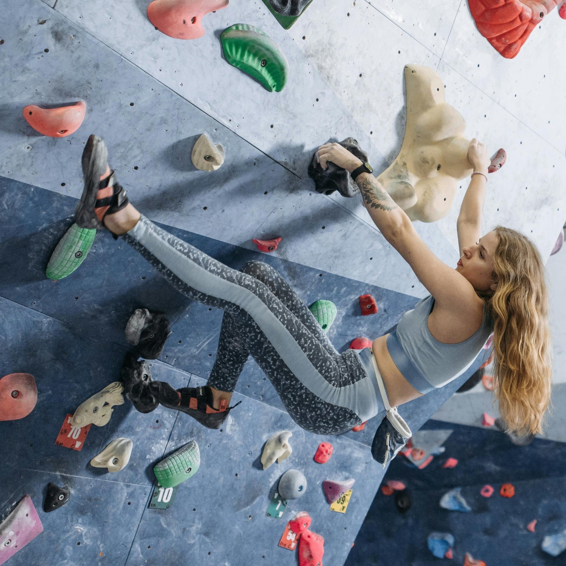 Person climbing on a rock wall with colorful holds